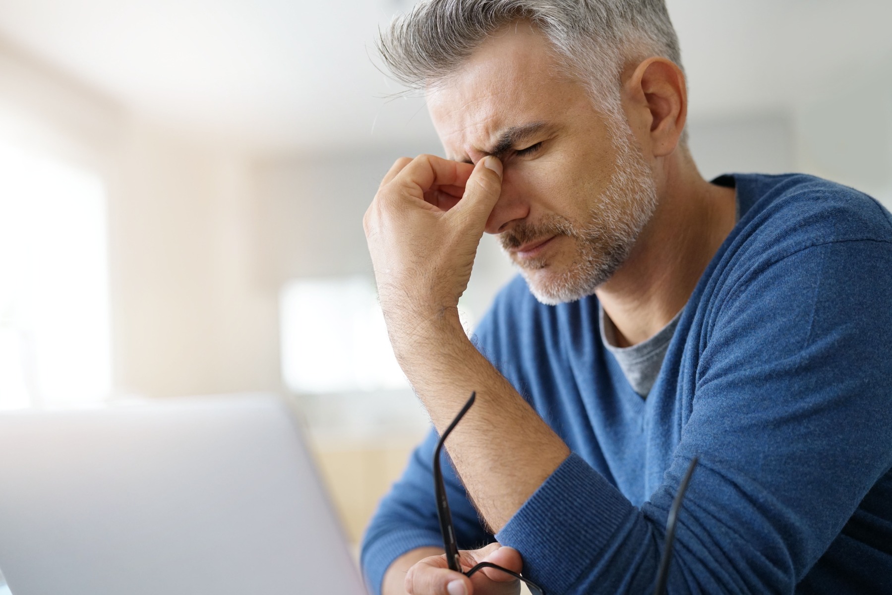 Man holding his head with a headache