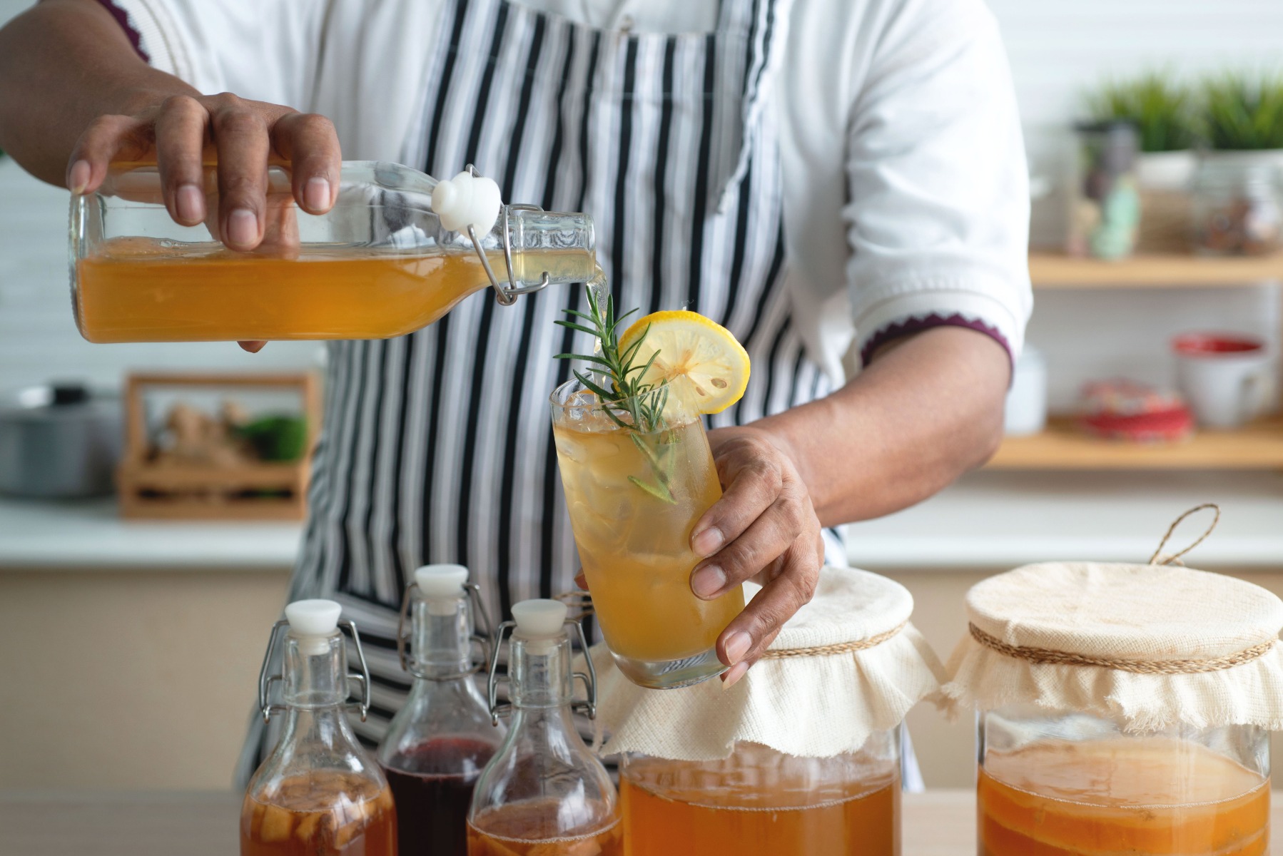 Someone pouring Kombucha in a glass