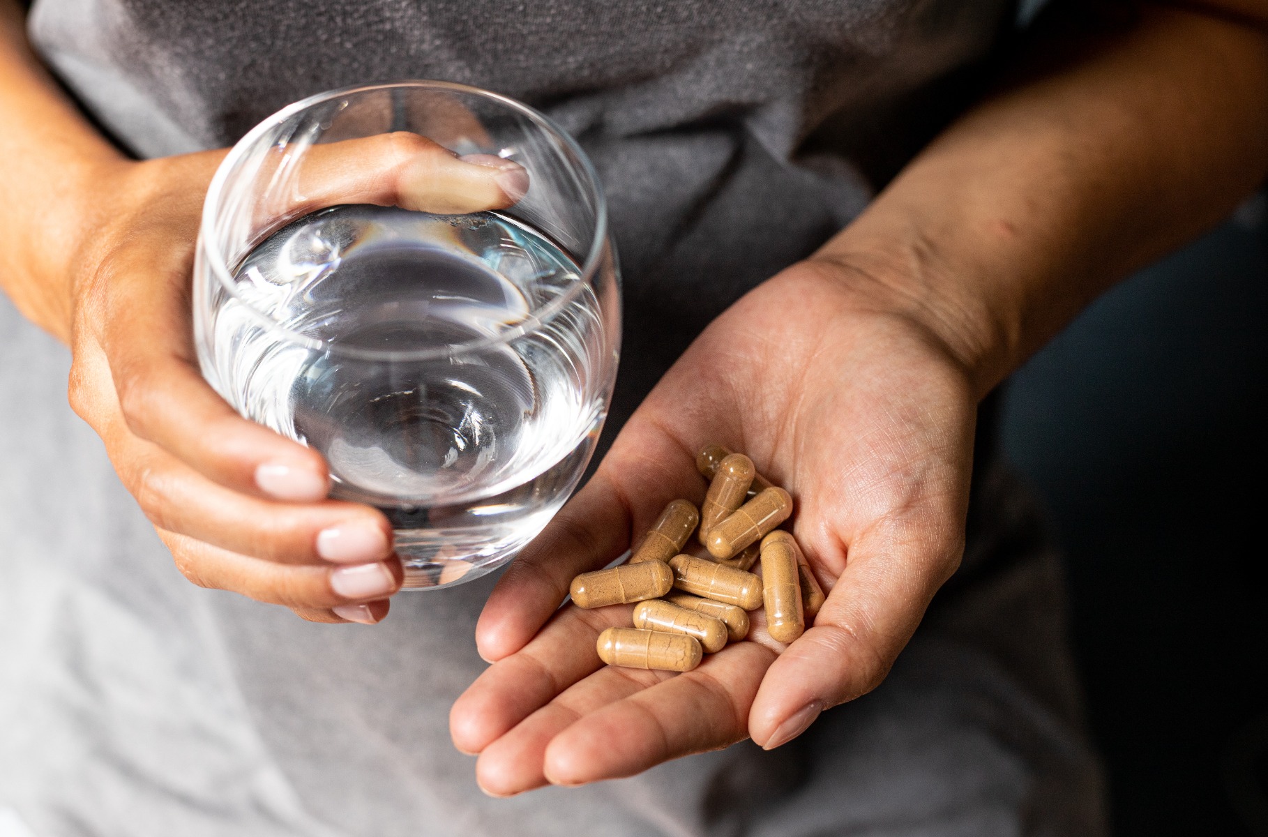 Someone holding a handful of Ashwagandha Capsules